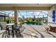 Outdoor pool area with patio, tables, chairs, and a screened-in enclosure, perfect for entertaining guests at 17702 Cresswind Ter, Bradenton, FL 34211