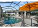 Relaxing screened-in pool with lounge chairs, a dining set, and lush landscaping for ultimate outdoor experience at 17702 Cresswind Ter, Bradenton, FL 34211