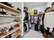 Organized walk-in closet with wooden shelving and ample storage space for clothes and accessories at 17702 Cresswind Ter, Bradenton, FL 34211