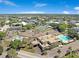 Aerial view of community with pool, tennis courts, and clubhouse at 2434 Australia E Way # 42, Clearwater, FL 33763