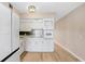 White kitchen cabinets, tile backsplash, and stainless steel appliances at 2434 Australia E Way # 42, Clearwater, FL 33763