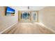 Bright living room with wood-look floors and sliding glass doors at 2434 Australia E Way # 42, Clearwater, FL 33763