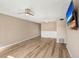 Living room featuring light walls, wood-look floors, and ceiling fan at 2434 Australia E Way # 42, Clearwater, FL 33763