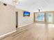 Spacious living room, wood-look floors, and large windows at 2434 Australia E Way # 42, Clearwater, FL 33763