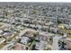 Aerial view showing a neighborhood with houses, pools and palm trees at 3105 Pinon Dr, Holiday, FL 34691