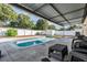 Enjoy this refreshing pool with covered patio and seating at 333 Shore E Dr, Oldsmar, FL 34677