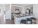 Modern kitchen with gray cabinets, granite countertops, and stainless steel appliances at 36023 Sunflower Hill Dr, Zephyrhills, FL 33541