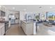 Open concept kitchen with island and stainless steel appliances at 36049 Sunflower Hill Dr, Zephyrhills, FL 33541