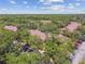 Community buildings nestled among lush trees and ample parking, showcasing the serene atmosphere and convenient residential living at 5606 Pinnacle Heights Cir # 304, Tampa, FL 33624