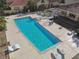 Aerial view of community pool, showing lounge chairs and lush landscaping around the edges at 5606 Pinnacle Heights Cir # 304, Tampa, FL 33624