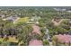 Overhead shot of residential buildings with lush trees and a nearby pond, showcasing the community's blend of nature and housing at 5606 Pinnacle Heights Cir # 304, Tampa, FL 33624