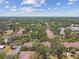 Expansive aerial view of residential buildings nestled among trees, highlighting the community's lush landscape and serene atmosphere at 5606 Pinnacle Heights Cir # 304, Tampa, FL 33624