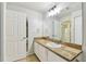 Bathroom featuring a large mirror, neutral colored tile countertops, and white cabinets at 5606 Pinnacle Heights Cir # 304, Tampa, FL 33624