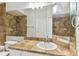Tiled bathroom with sink, large mirror and shower at 5606 Pinnacle Heights Cir # 304, Tampa, FL 33624
