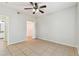 Neutral painted bedroom with tile floors features a view of the bathroom in the background at 5606 Pinnacle Heights Cir # 304, Tampa, FL 33624