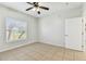 Bright bedroom featuring a ceiling fan and a window with views of outside trees at 5606 Pinnacle Heights Cir # 304, Tampa, FL 33624