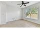 Bright bedroom with a ceiling fan, neutral paint, tile flooring and a window offering great natural light at 5606 Pinnacle Heights Cir # 304, Tampa, FL 33624