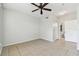 Spacious bedroom with tile flooring, ceiling fan, and hallway and bathroom views at 5606 Pinnacle Heights Cir # 304, Tampa, FL 33624