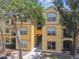 Inviting three-story apartment building exterior featuring well-maintained landscaping at 5606 Pinnacle Heights Cir # 304, Tampa, FL 33624