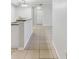 Bright hallway with clean lines and neutral tile flooring leading to multiple rooms at 5606 Pinnacle Heights Cir # 304, Tampa, FL 33624