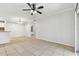 Living room with tile floors, ceiling fan, and kitchen at 5606 Pinnacle Heights Cir # 304, Tampa, FL 33624