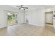Living room with tile floors, sliding door to balcony, and entry door at 5606 Pinnacle Heights Cir # 304, Tampa, FL 33624