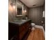 Elegant bathroom with dark wood vanity and concrete countertop at 700 Beach E Dr # Ph 2, St Petersburg, FL 33701