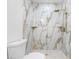 Bathroom with marble shower and gold fixtures at 7812 N Woodlynne Ave, Tampa, FL 33614