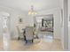 Elegant dining room with a chandelier and seating for four at 11115 66Th Ter, Seminole, FL 33772