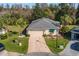 Aerial view of single-story house with driveway and landscaping at 11116 Jenkins Ct, San Antonio, FL 33576