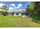 Expansive backyard with lush green lawn and relaxing screened lanai at 11116 Jenkins Ct, San Antonio, FL 33576
