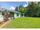 Spacious backyard featuring a well-maintained lawn and screened-in patio at 11116 Jenkins Ct, San Antonio, FL 33576