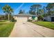 House exterior showcasing a driveway and landscaping at 11116 Jenkins Ct, San Antonio, FL 33576