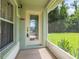 Inviting front entryway with a decorative glass door and screened porch at 11116 Jenkins Ct, San Antonio, FL 33576