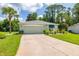 Inviting single-story home with a well-kept lawn and attached garage at 11116 Jenkins Ct, San Antonio, FL 33576