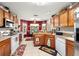 Bright kitchen with wood cabinets, an island, and stainless steel appliances at 11116 Jenkins Ct, San Antonio, FL 33576