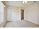 Bright bedroom with neutral walls, carpet flooring, and a ceiling fan at 11609 Weaver Park Ct, Trinity, FL 34655