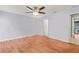 Light and airy bedroom with wood floors and an adjacent bathroom at 1200 Tarpon Woods Blvd # R7, Palm Harbor, FL 34685