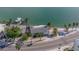 Aerial view of waterfront home with lush landscaping at 1207 Pass A Grille Way, St Pete Beach, FL 33706