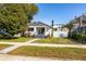 Updated bungalow home exterior showcasing a freshly painted facade and a well-maintained lawn at 1223 13Th N St, St Petersburg, FL 33705