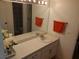 Double vanity bathroom with a large mirror and plenty of cabinet space at 12300 Vonn Rd # 6103, Largo, FL 33774