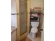 Bathroom with shower, toilet, and storage shelving at 12300 Vonn Rd # 6103, Largo, FL 33774