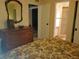 Bedroom with dresser and view of ensuite bathroom at 12300 Vonn Rd # 6103, Largo, FL 33774