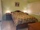 Spacious bedroom with a floral comforter and nightstands at 12300 Vonn Rd # 6103, Largo, FL 33774