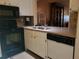 Efficient kitchen featuring black appliances and a double sink at 12300 Vonn Rd # 6103, Largo, FL 33774