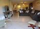 Living area featuring sectional sofa and view to entry at 12300 Vonn Rd # 6103, Largo, FL 33774