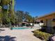 Community pool with surrounding patio and lush landscaping at 12300 Vonn Rd # 6103, Largo, FL 33774