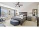 Spacious Primary bedroom with a king-size bed and seating area at 12449 Country White Cir, Tampa, FL 33635