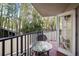 Private balcony with table and chairs, overlooking lush tropical foliage at 1420 Bayshore Blvd # 209, Dunedin, FL 34698