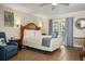 Spacious bedroom showcasing a plush bed, balcony access, and serene decor at 1420 Bayshore Blvd # 209, Dunedin, FL 34698